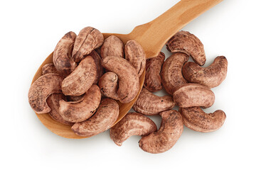 cashew nuts heap with shell in wooden spoon isolated on white background. Top view. Flat lay