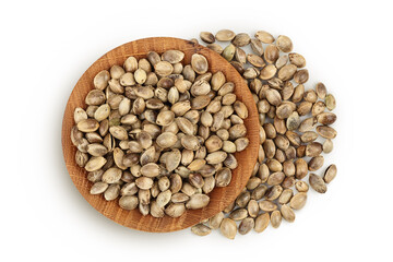 Hemp seeds in wooden bowl isolated on white background with full depth of field. Top view. Flat lay