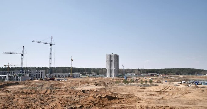 Urban Expansion Unveiled: Preparing the Site for a Majestic Skyscraper with Towering Cranes and Construction Equipment
