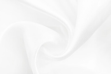 A twisted piece of white fabric. White material or texture with waves and folds. Wrinkled white fabric