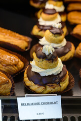 Assortment of french fresh baked sweet pastry with chocolate in confectionery shop in Paris, english translation is religious chocolate cake