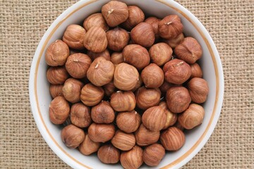 Hazelnut on eco canvas napkin background. Healthy eating diet, nutrition, vegan concept. Protein organic food. Dry snack. National nut day. Copy space for text