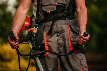 Farmer dressing up and putting on mowing green grass in his backyard