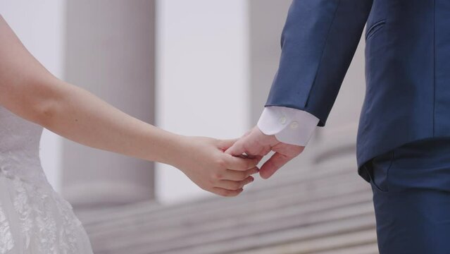 bride and groom holding hands