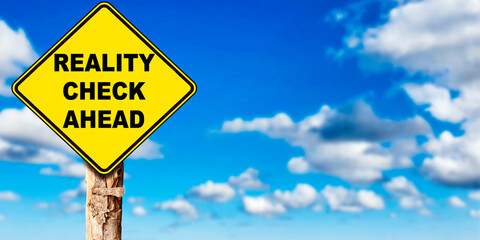 Reality Check Ahead yellow road sign with sky clouds background