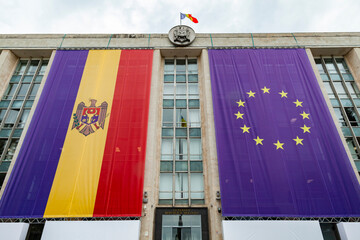 Large flags of the Republic of Moldova and the European Union on the building of the government of...