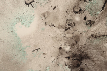 Black ink blot and watercolor drop splash blots on light beige paper background.