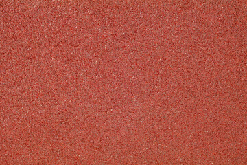 Background texture of sandpaper close-up, red granular homogeneous abrasive structure