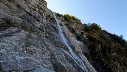 Fototapeta na wymiar beautiful mountain ridge highland fast waterfall at summertime day - photo of nature