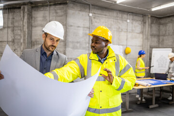 Contractor and construction engineer working together on new building project.