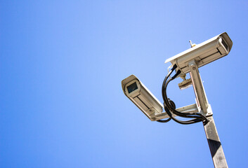 Surveillance cameras against the sky. Surveillance cameras, security. Video recording, security of objects.