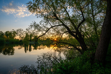 Fototapeta na wymiar The sun sets over the lake.