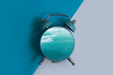 alarm clock sea on a light background
