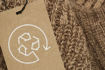 Close up of clothing tag with recycle icon. Recycling products concept. Zero waste, suistainale...