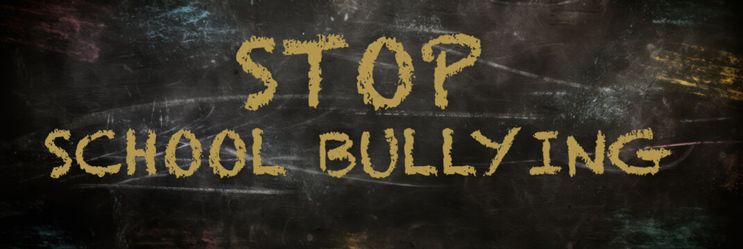 Stop school bullying phrase written in blackboard with yellow chalk. Generative AI.