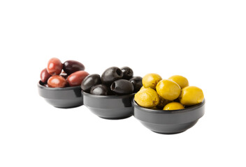 Bowl with olives isolated on white background. Delicious black, green and red olives with leaves in plates on a white background. Fresh olive fruits.