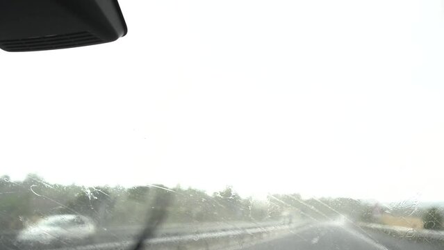 video from the front passenger window in heavy rain in storm and windscreen wipers blowing the water out very fast