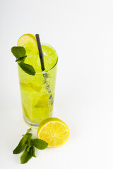 Fresh cocktail on ice with lime, lemon and mint on a white background