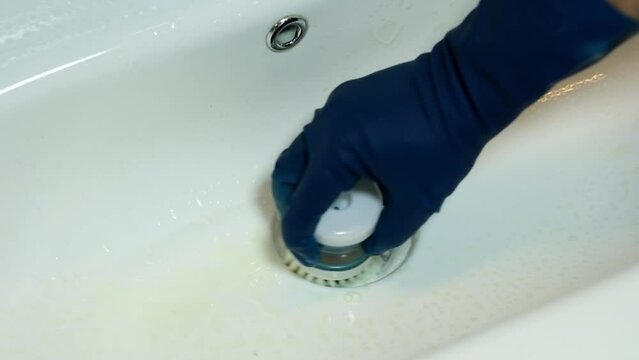 man washing his hands, cleaner scrubbing sink, cleaning concept at home