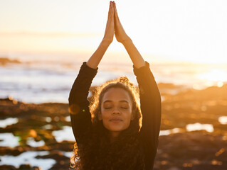 Woman, beach yoga and sunset with pray hands, eyes closed and peace of mind in summer sunshine. Girl, zen meditation and mindfulness for health, wellness and exercise by ocean with stretching outdoor