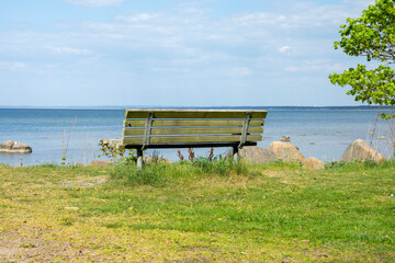 Empty bench by the sea