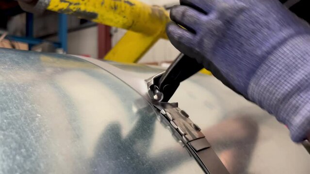 videobcloseup of an unrecognizable worker cutting the safety strapping to a metal coil in a metallurgical factory industry