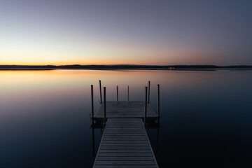 calm lake at sunset with jetty - 605816115
