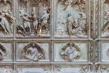 Detail of a bronze door of Milan cathedral, Italy