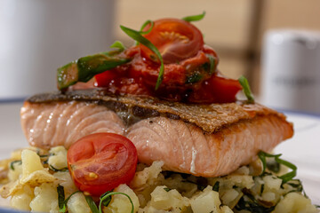 Salmon fillet grilled, fried potato and fresh vegetable green salad