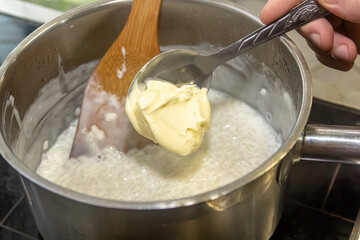 Barley porridge with butter in a saucepan. Recipe preparation step by step