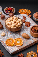 Fototapeta na wymiar Mix of roasted macadamia nuts, cashews, pecans, almonds, raisins and dry berries