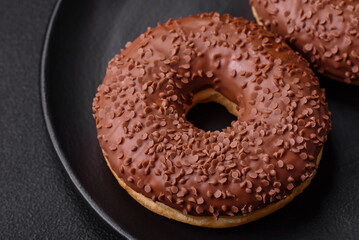 Delicious chocolate glazed donut sprinkled with chocolate chips