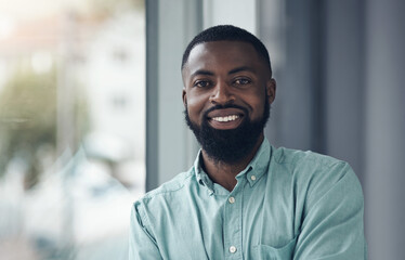 Naklejka premium African business man, portrait and smile by window with happiness, pride and entrepreneurship at startup. Black businessman, face and happy manager at company, success and confidence in finance job
