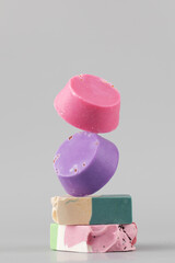Natural handmade soap. Bright pieces of soap balance on a grey background.