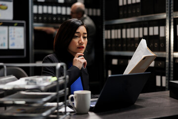 Bureaucratic administration employee checking accountancy budget plan data paperwork on laptop....