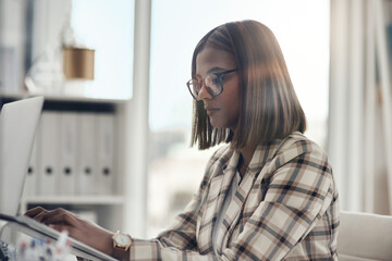 Laptop, editor and business woman typing in office workplace. Writer, computer and female Indian person reading, working or writing email, report or proposal, research online or planning project.