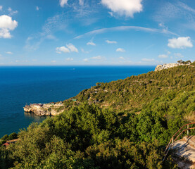 Fototapeta premium Summer sea perched Peschici town and cape Trabucco di Monte Pucci view, Gargano peninsula in Puglia, Italy