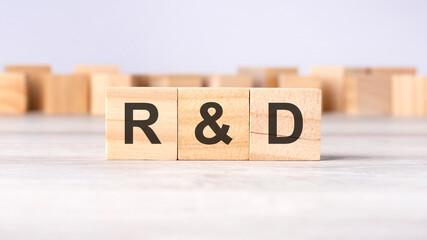 R and D - word concept written on wooden cubes or blocks, light background, front view