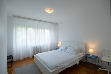 Fototapeta na wymiar Bedroom interior in rental apartment