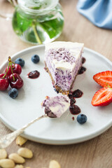 Cut of no baked raw cake made with coconut milk and blueberries