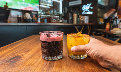 Taking drink by hand at bar table