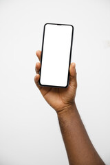 Black hand holding phone facing camera isolated on white background. blank screen, phone screen mockup, front view, clipping path, clipping mask