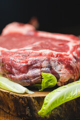 Raw tomahawk beef steak with ingredients for grilling