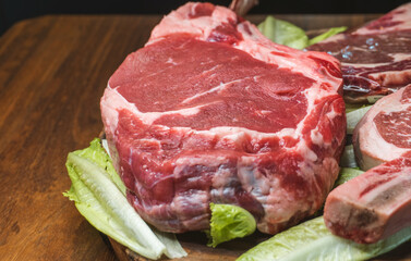 Raw tomahawk beef steak with ingredients for grilling