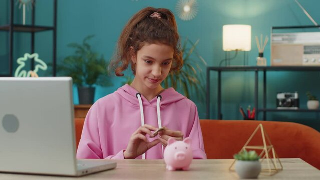 Caucasian preteen school girl putting one dollar cash money into piggy bank. Young child enjoying her first saving at home workplace sitting at the table. Kids and financial literacy budget planning