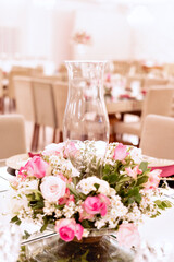 a glass vase with pink and white flowers