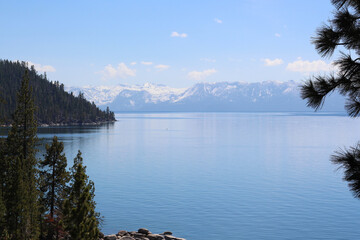 Lake Tahoe in California with mountains covered in snow on a sunny May day. Photo from above.