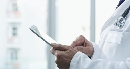 Senior man, doctor hands and tablet with digital research and data at a hospital and clinic. Healthcare, wellness and clinic employee with internet, web and medical information on tech with typing - Powered by Adobe