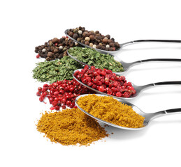 Metal spoons with different spices on white background