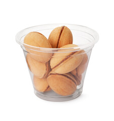 Delicious nut shaped cookies with boiled condensed milk in plastic up on white background